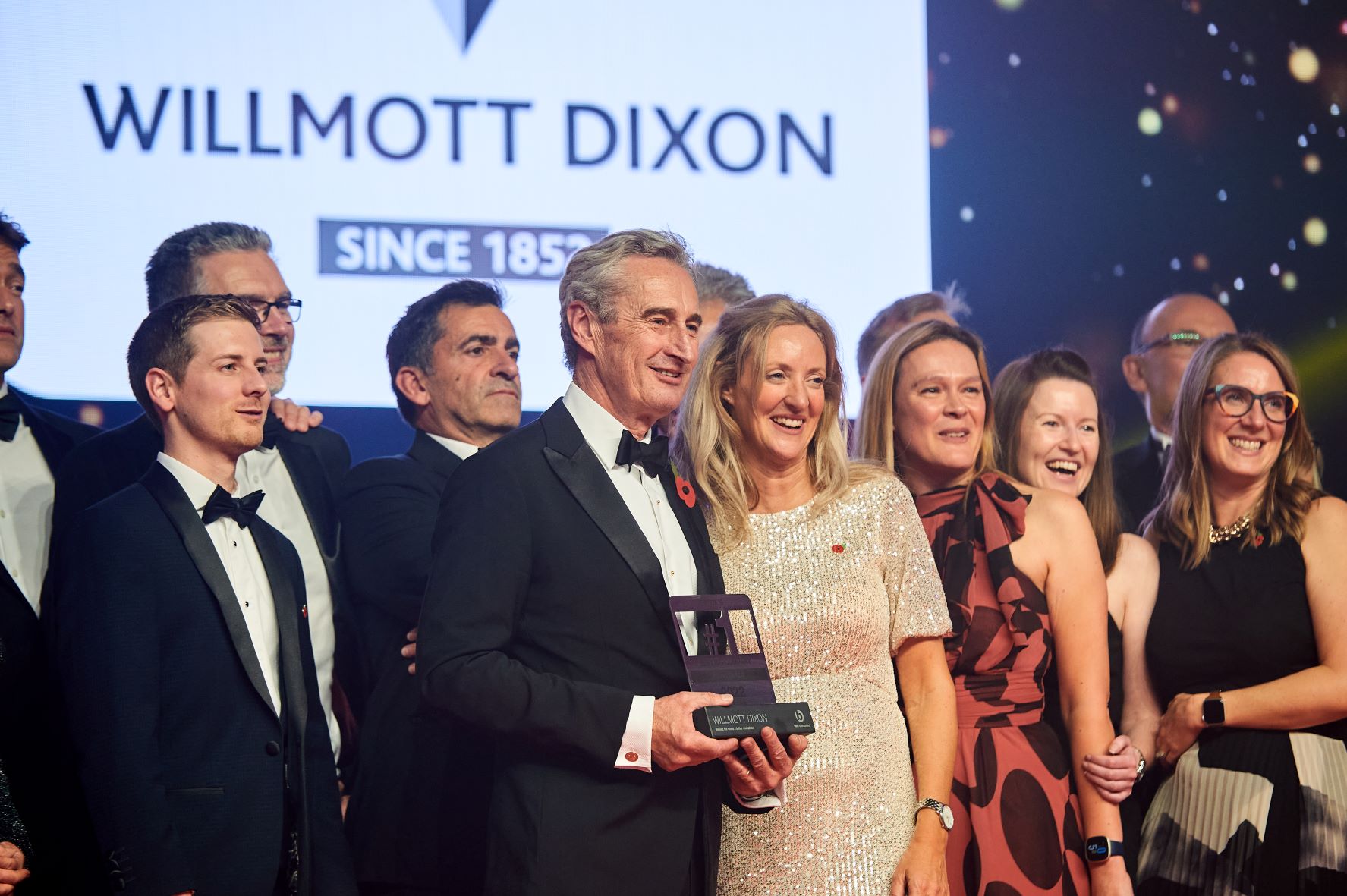 Rick Willmott with team on stage mid.JPG